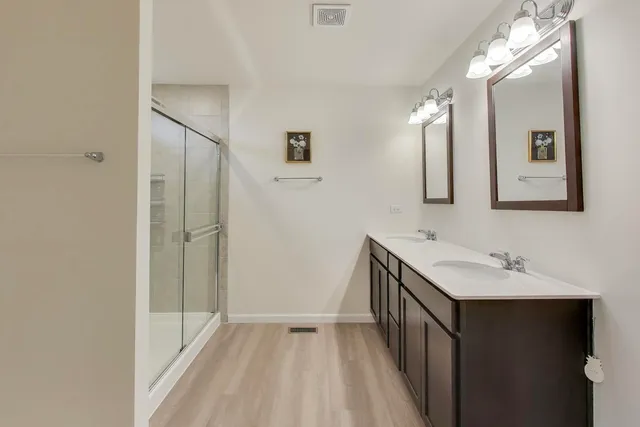 a bathroom with a double vanity sink and mirror