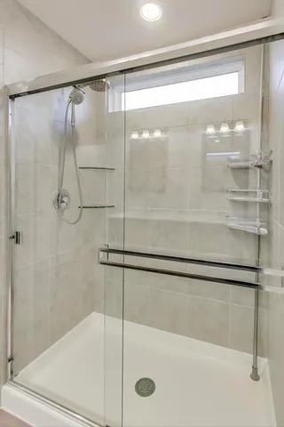 a bathroom with a glass shower door