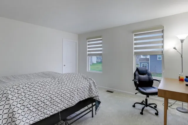 a bedroom with a bed and a desk