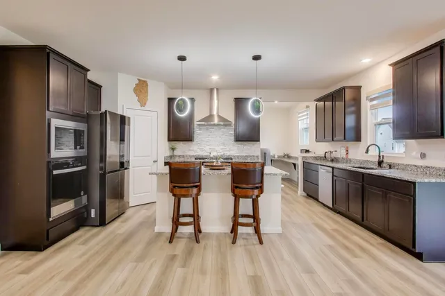 a large kitchen with a table and chairs