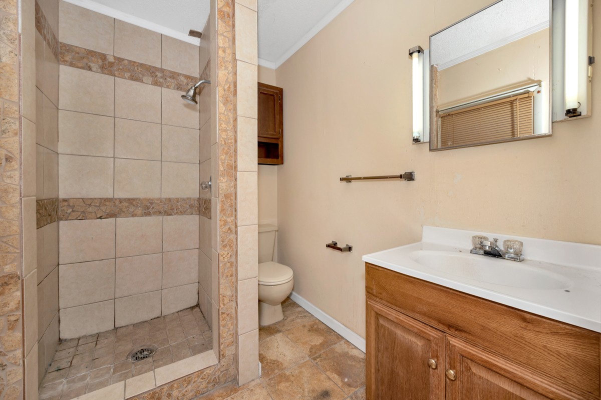 1121 Rolin Hollow Road Ardmore, TN 38449 - Photo 19 of 46 a bathroom with a sink toilet and shower