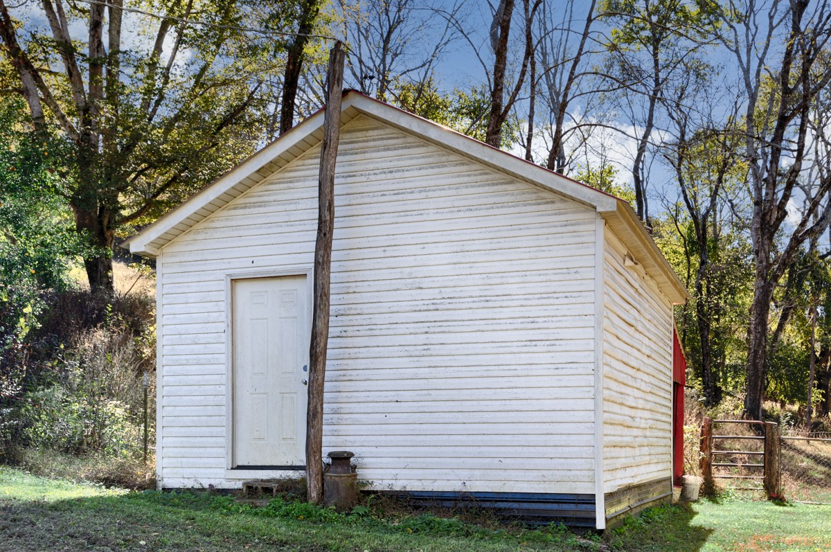 1121 Rolin Hollow Road Ardmore, TN 38449 - Photo 28 of 46 a view of a white house with a yard and large trees