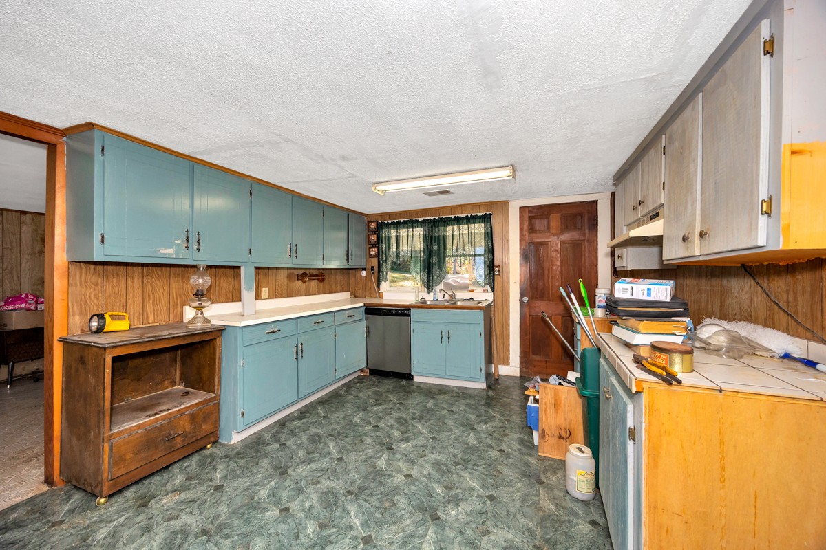 1121 Rolin Hollow Road Ardmore, TN 38449 - Photo 7 of 46 a kitchen with a sink a stove and cabinets