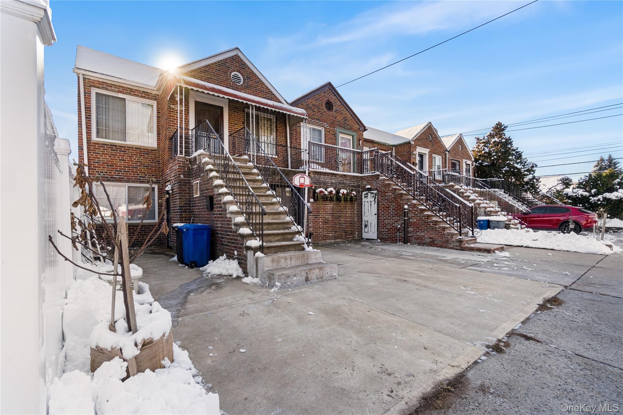 203-10 Murdock Avenue Queens, NY 11412 - Photo 2 of 18 View of front of property featuring stairs, brick siding, and covered porch