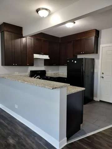 a kitchen with stainless steel appliances a refrigerator and a microwave