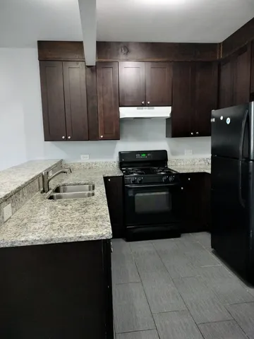 a kitchen with a stove and a refrigerator