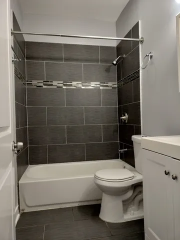 a bathroom with a toilet and a bathtub