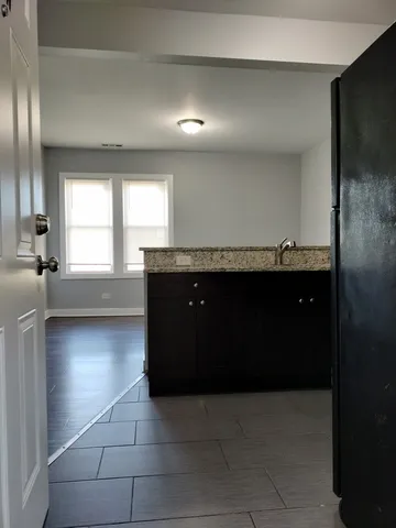 a kitchen with a refrigerator and a sink
