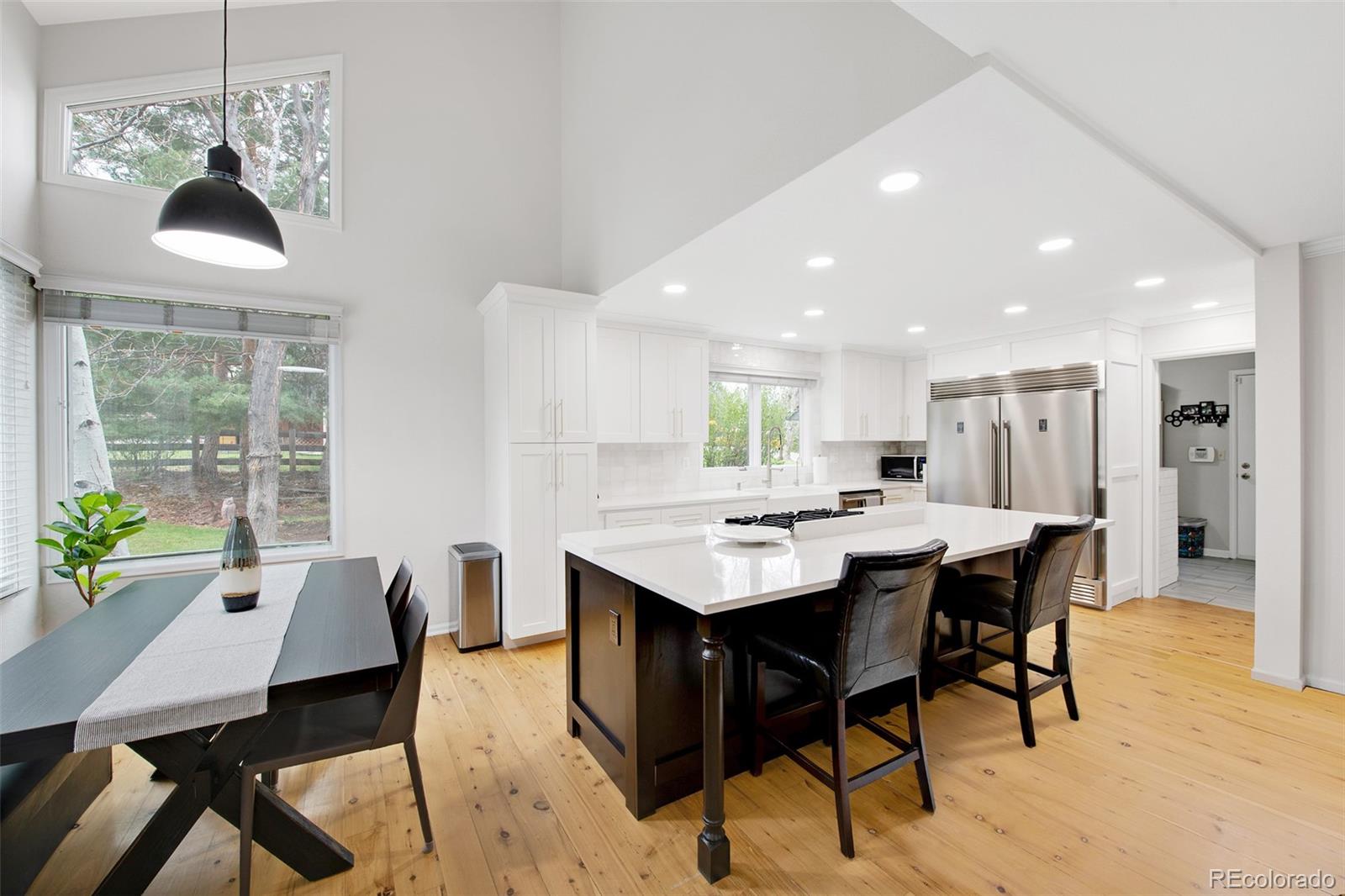 4 Mule Deer Trail Littleton, CO 80127 - Photo 12 of 40 a kitchen with a table and chairs in it