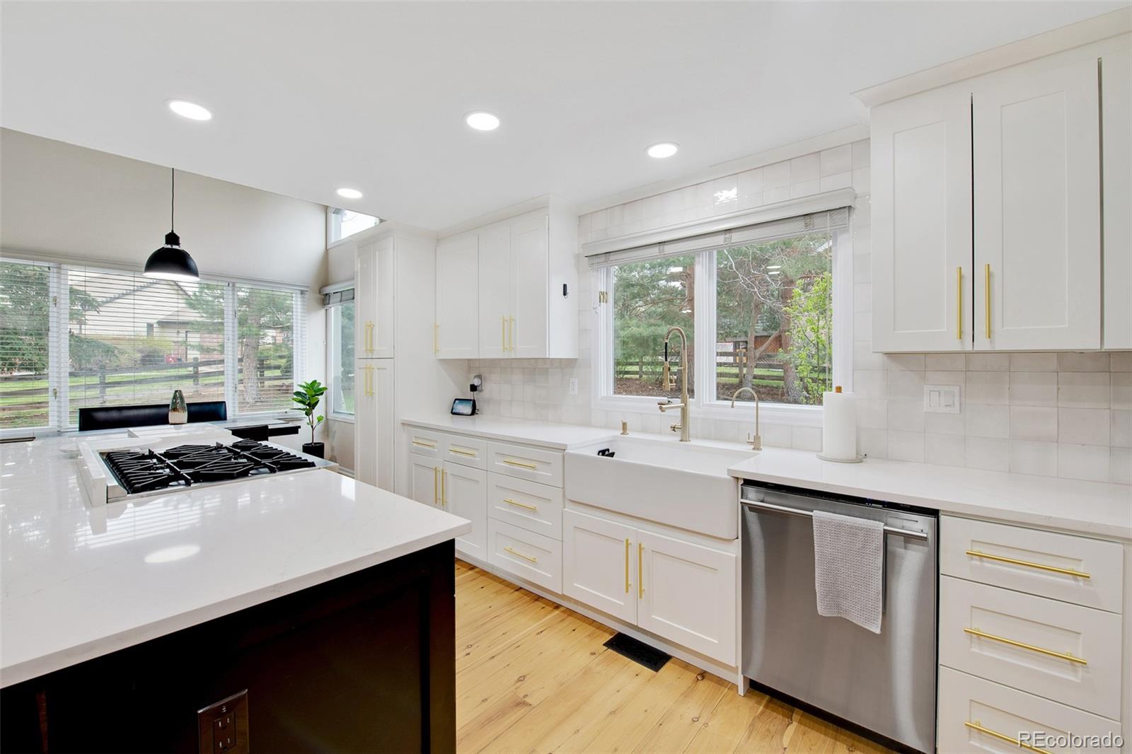 4 Mule Deer Trail Littleton, CO 80127 - Photo 14 of 40 a kitchen with a sink stove and cabinets