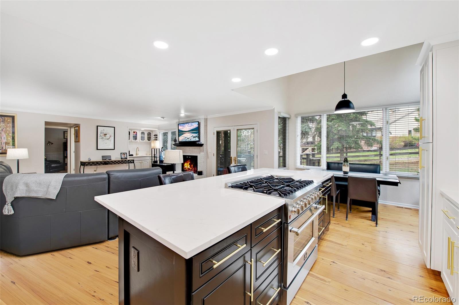 4 Mule Deer Trail Littleton, CO 80127 - Photo 15 of 40 a kitchen with a stove a refrigerator and wooden floor