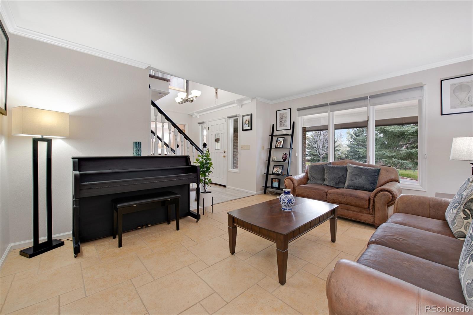 4 Mule Deer Trail Littleton, CO 80127 - Photo 19 of 40 a living room with furniture and a piano