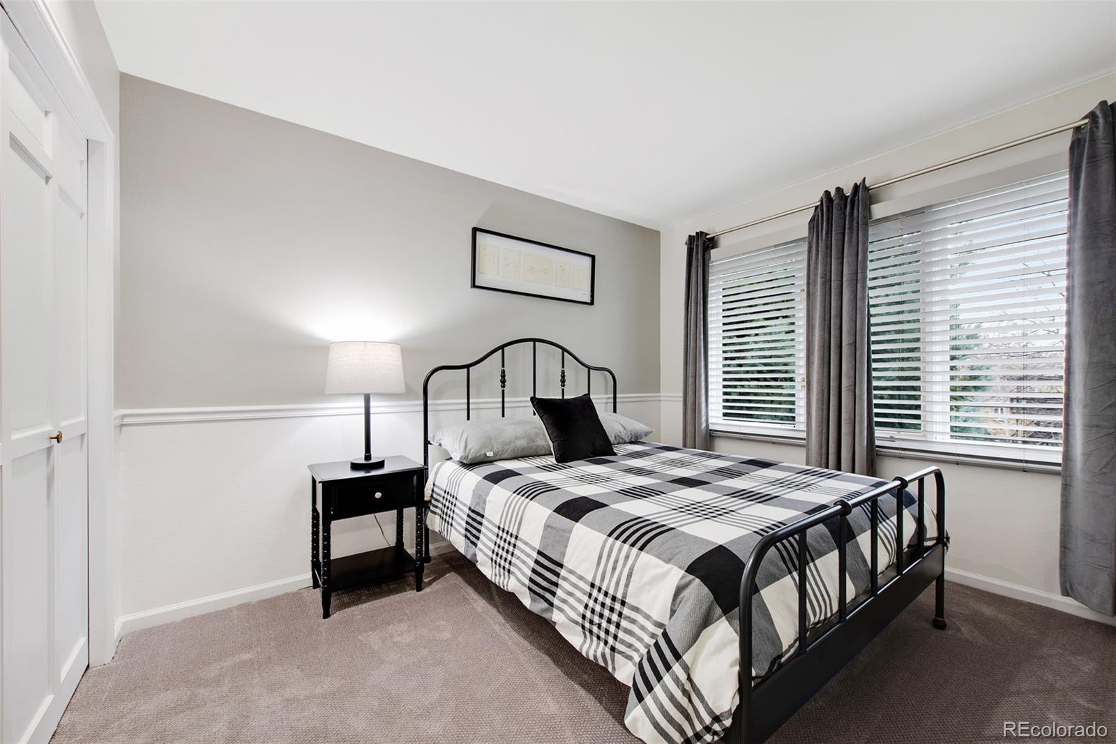 4 Mule Deer Trail Littleton, CO 80127 - Photo 25 of 40 a bedroom with a bed and a window