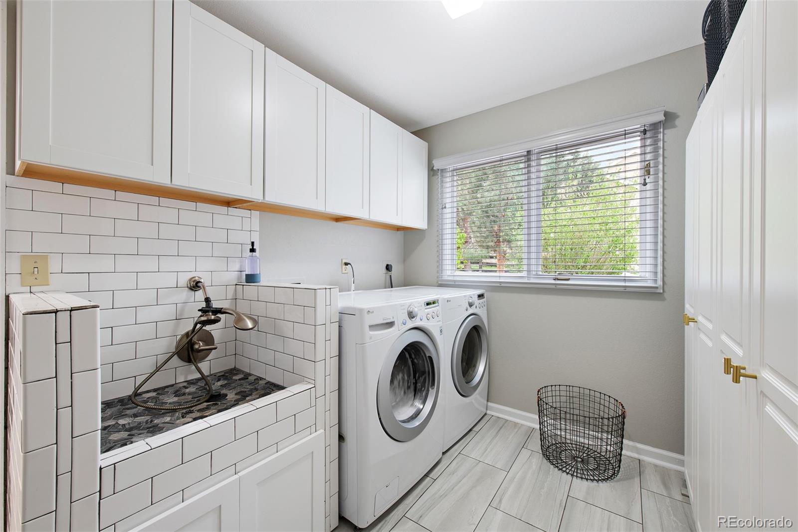 4 Mule Deer Trail Littleton, CO 80127 - Photo 26 of 40 a utility room with sink dryer and washer