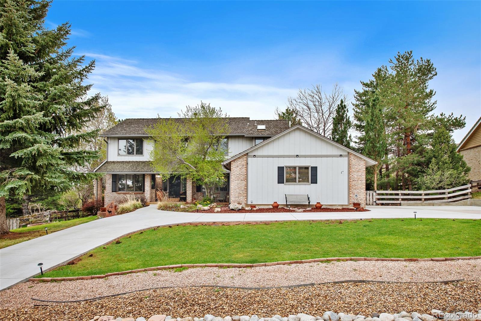 4 Mule Deer Trail Littleton, CO 80127 - Photo 3 of 40 a front view of a house with a yard