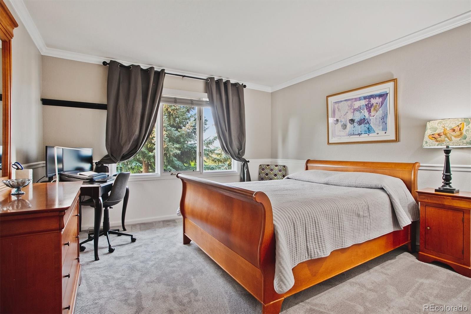 4 Mule Deer Trail Littleton, CO 80127 - Photo 31 of 40 a bed sitting in a bedroom next to a window