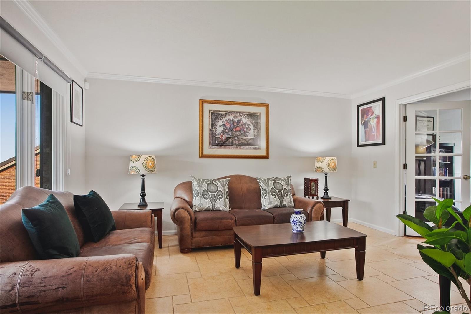 4 Mule Deer Trail Littleton, CO 80127 - Photo 6 of 40 a living room with furniture and a potted plant