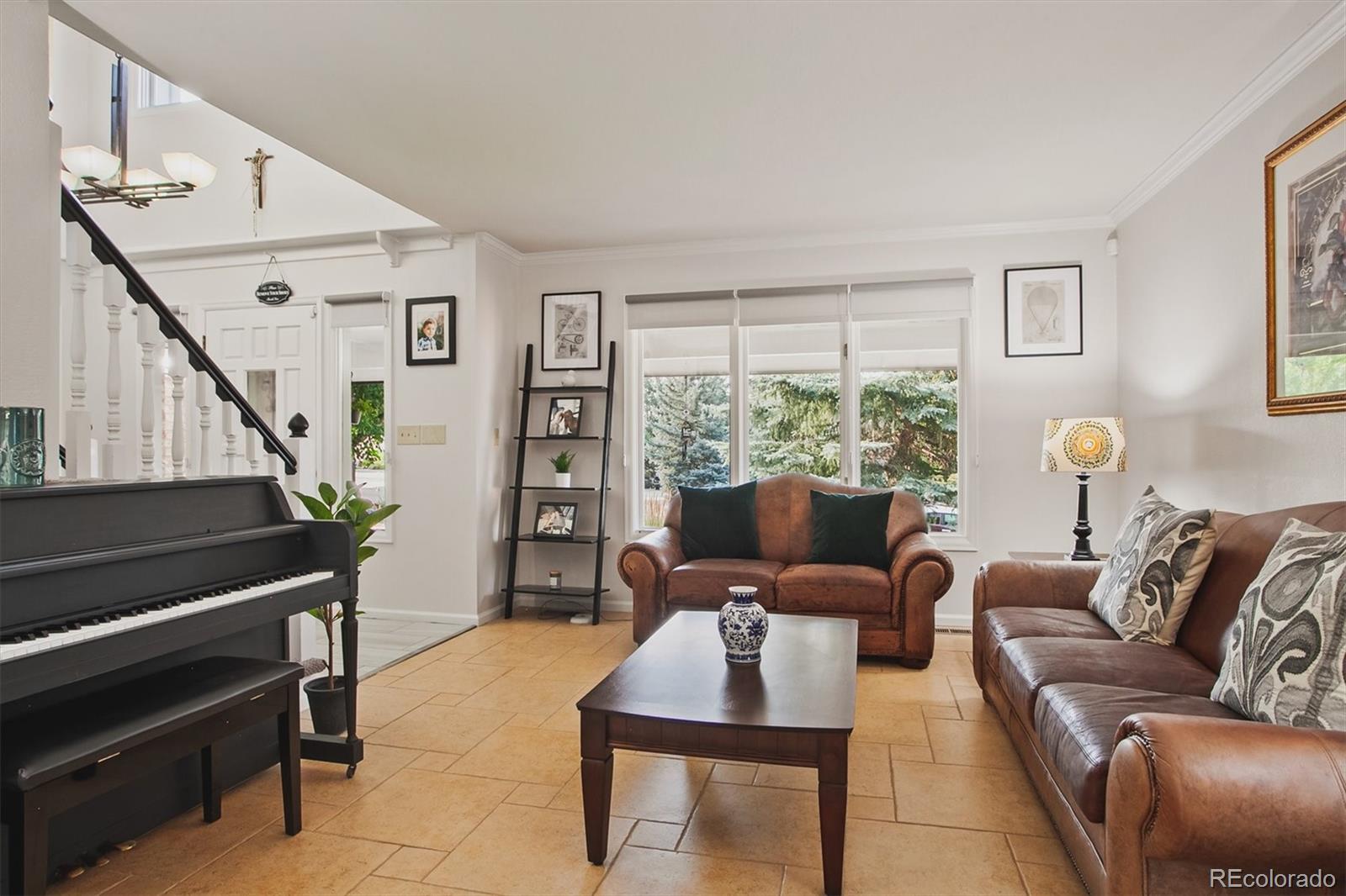 4 Mule Deer Trail Littleton, CO 80127 - Photo 7 of 40 a living room with furniture and a window