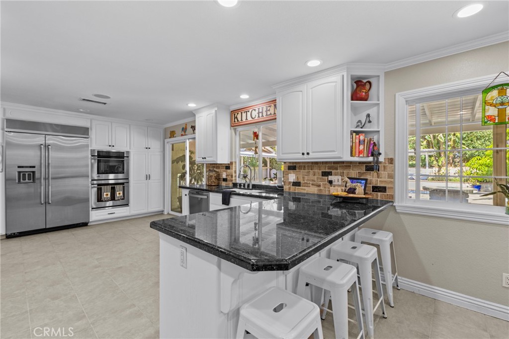 1446 Los Conejos Road Fallbrook, CA 92028 - Photo 14 of 66 a kitchen with stainless steel appliances granite countertop a sink a stove and a refrigerator