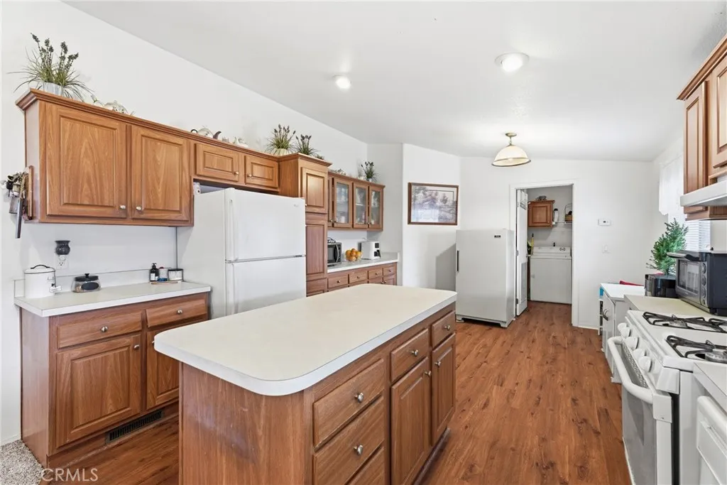 20843 Waalew Road, Unit C48 Apple Valley, CA 92307 - Photo 11 of 33 a kitchen with a stove a sink dishwasher and a refrigerator