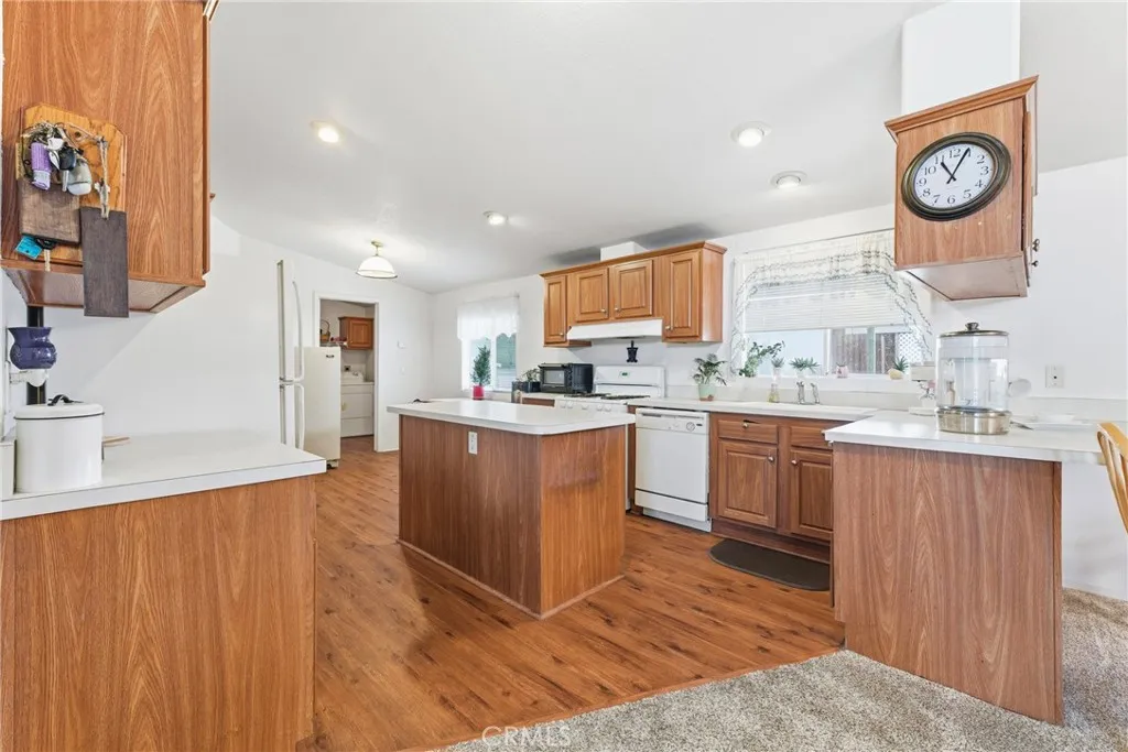 20843 Waalew Road, Unit C48 Apple Valley, CA 92307 - Photo 13 of 33 a kitchen with stainless steel appliances granite countertop a sink wooden cabinets and a refrigerator