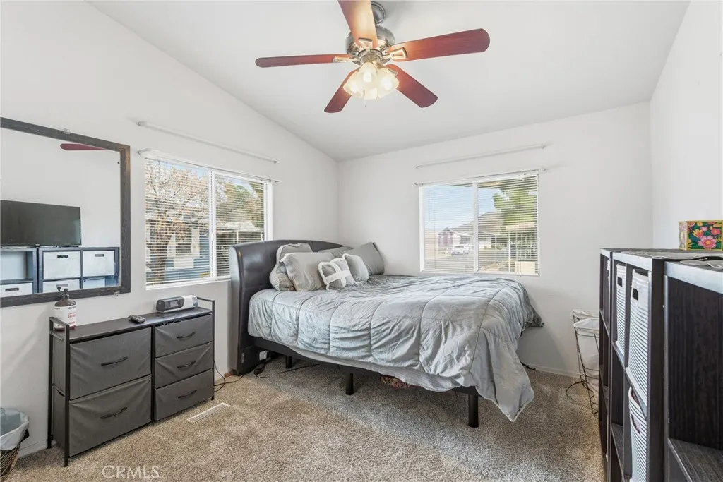 20843 Waalew Road, Unit C48 Apple Valley, CA 92307 - Photo 23 of 33 a bedroom with a bed dresser and a window