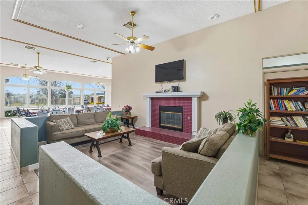 20843 Waalew Road, Unit C48 Apple Valley, CA 92307 - Photo 28 of 33 a living room with furniture a fireplace and a flat screen tv