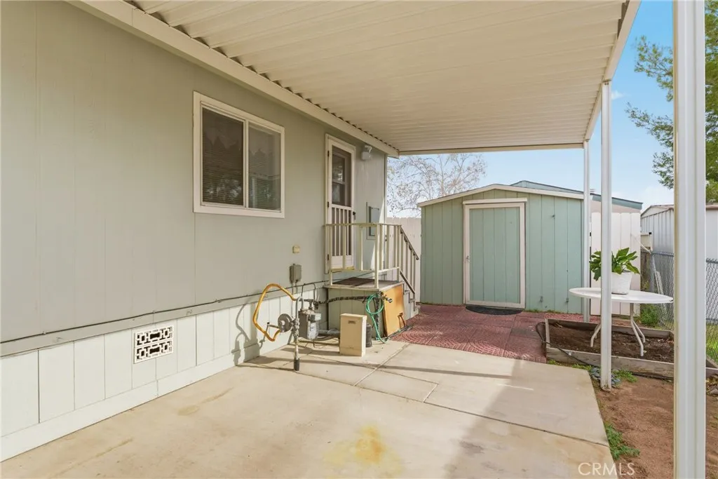 20843 Waalew Road, Unit C48 Apple Valley, CA 92307 - Photo 5 of 33 a view of a chair and table in front of house