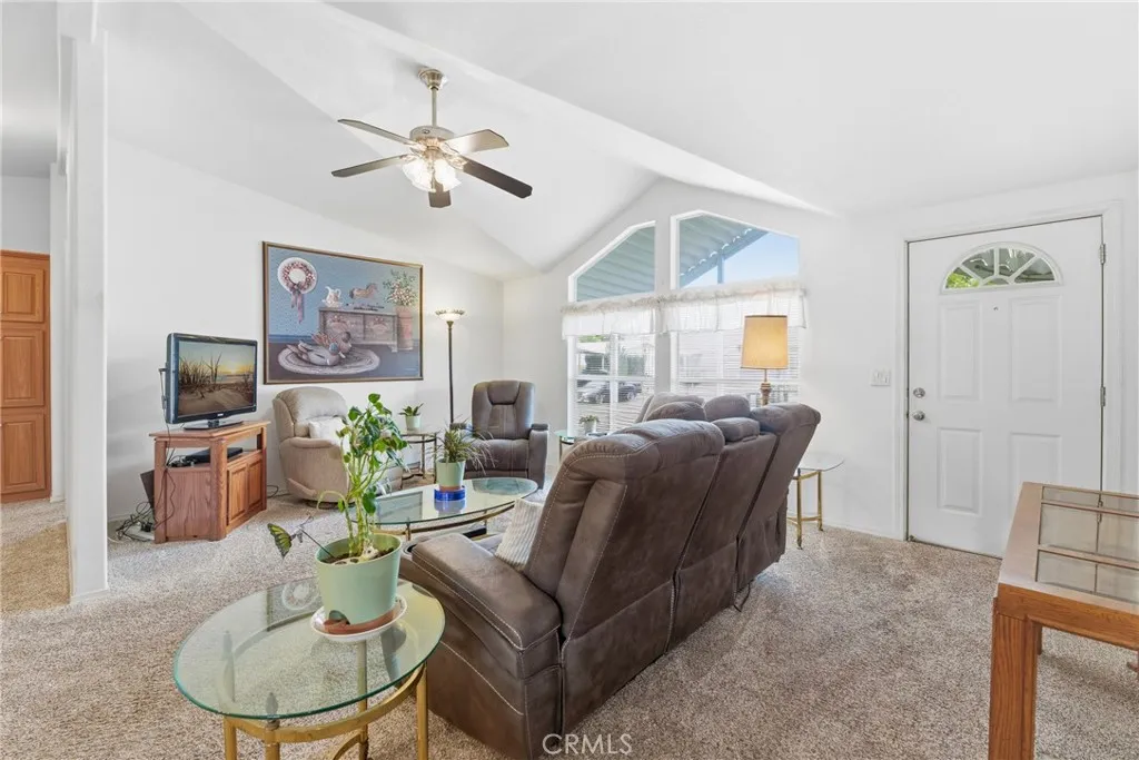 20843 Waalew Road, Unit C48 Apple Valley, CA 92307 - Photo 8 of 33 a living room with furniture a large window and a flat screen tv