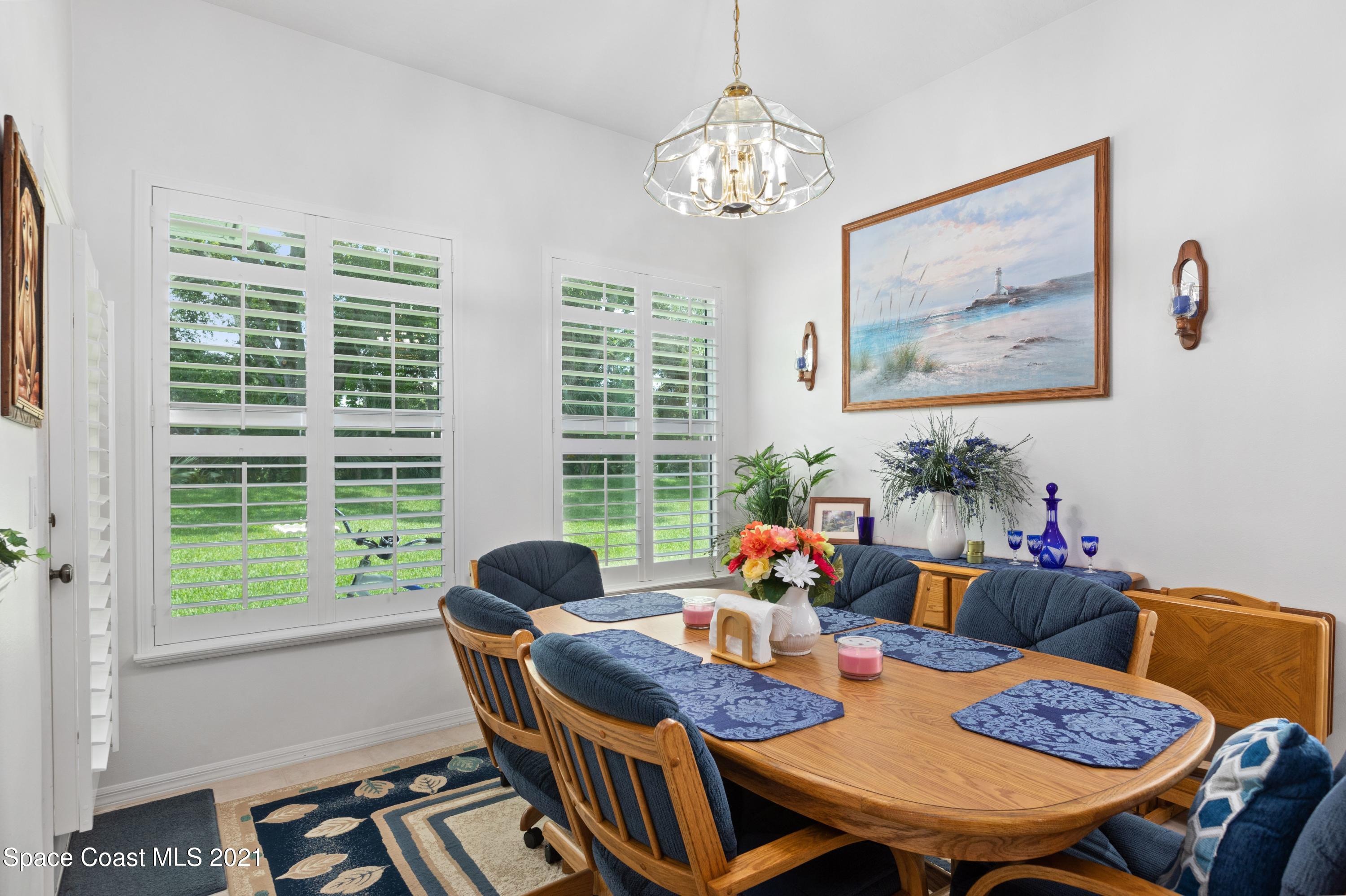 1120 Meadowbrook Road Northeast Palm Bay, FL 32905 - Photo 12 of 33 a view of a dining room with furniture window and outside view