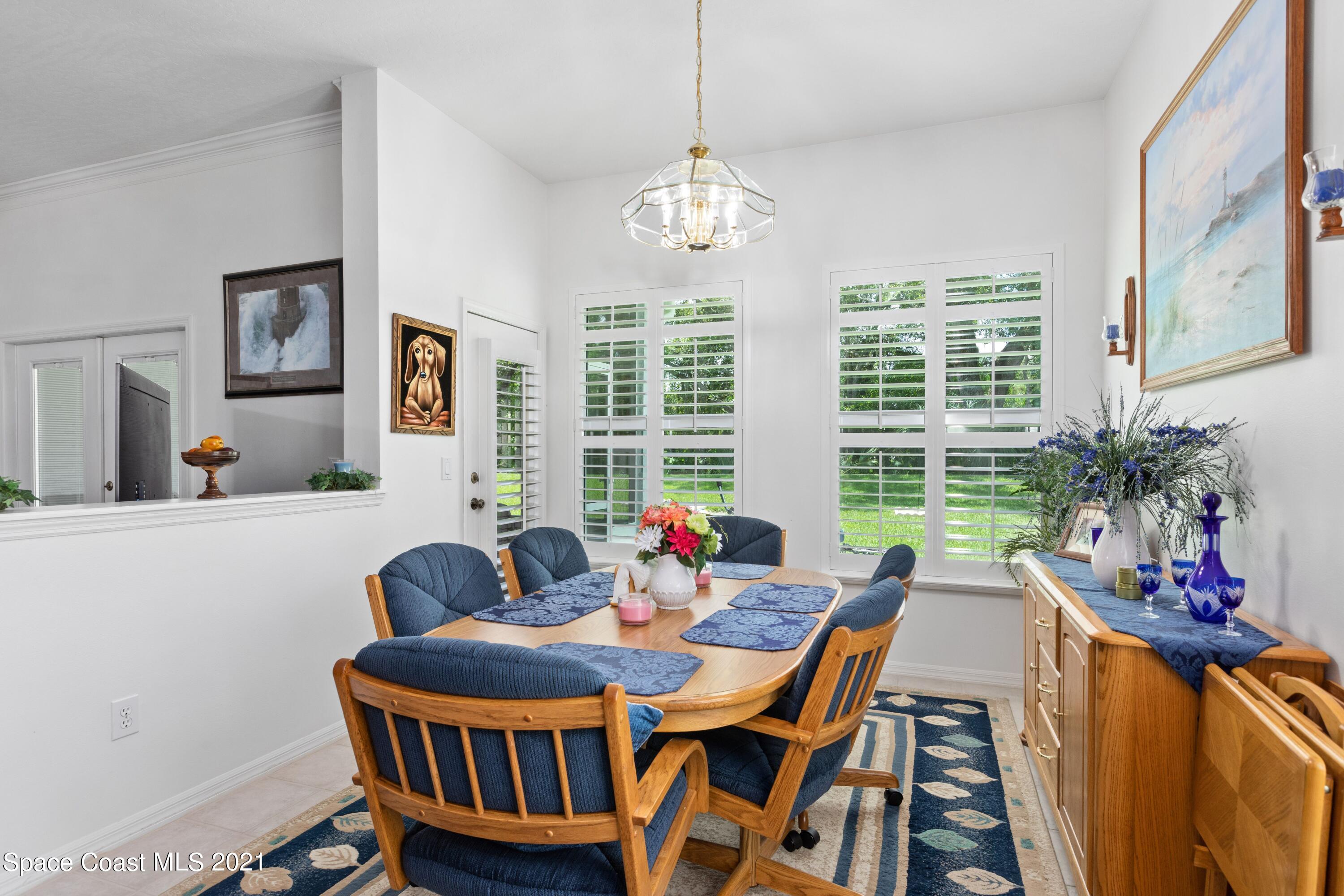 1120 Meadowbrook Road Northeast Palm Bay, FL 32905 - Photo 13 of 33 a view of a dining room with furniture window and outside view