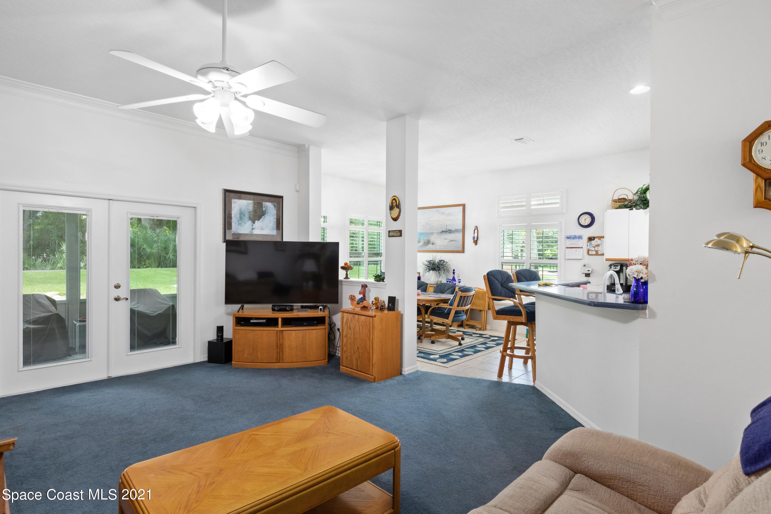 1120 Meadowbrook Road Northeast Palm Bay, FL 32905 - Photo 15 of 33 a living room with furniture and a flat screen tv