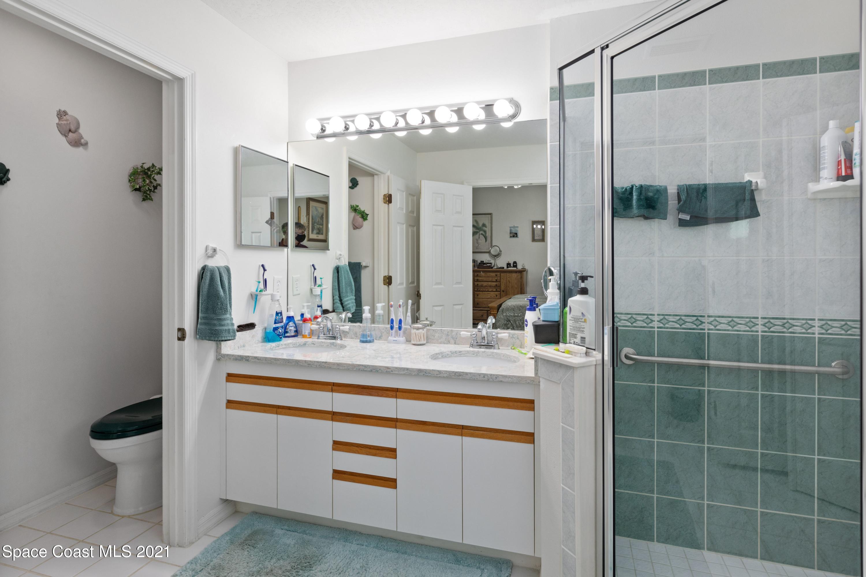 1120 Meadowbrook Road Northeast Palm Bay, FL 32905 - Photo 20 of 33 a bathroom with a sink a toilet and shower