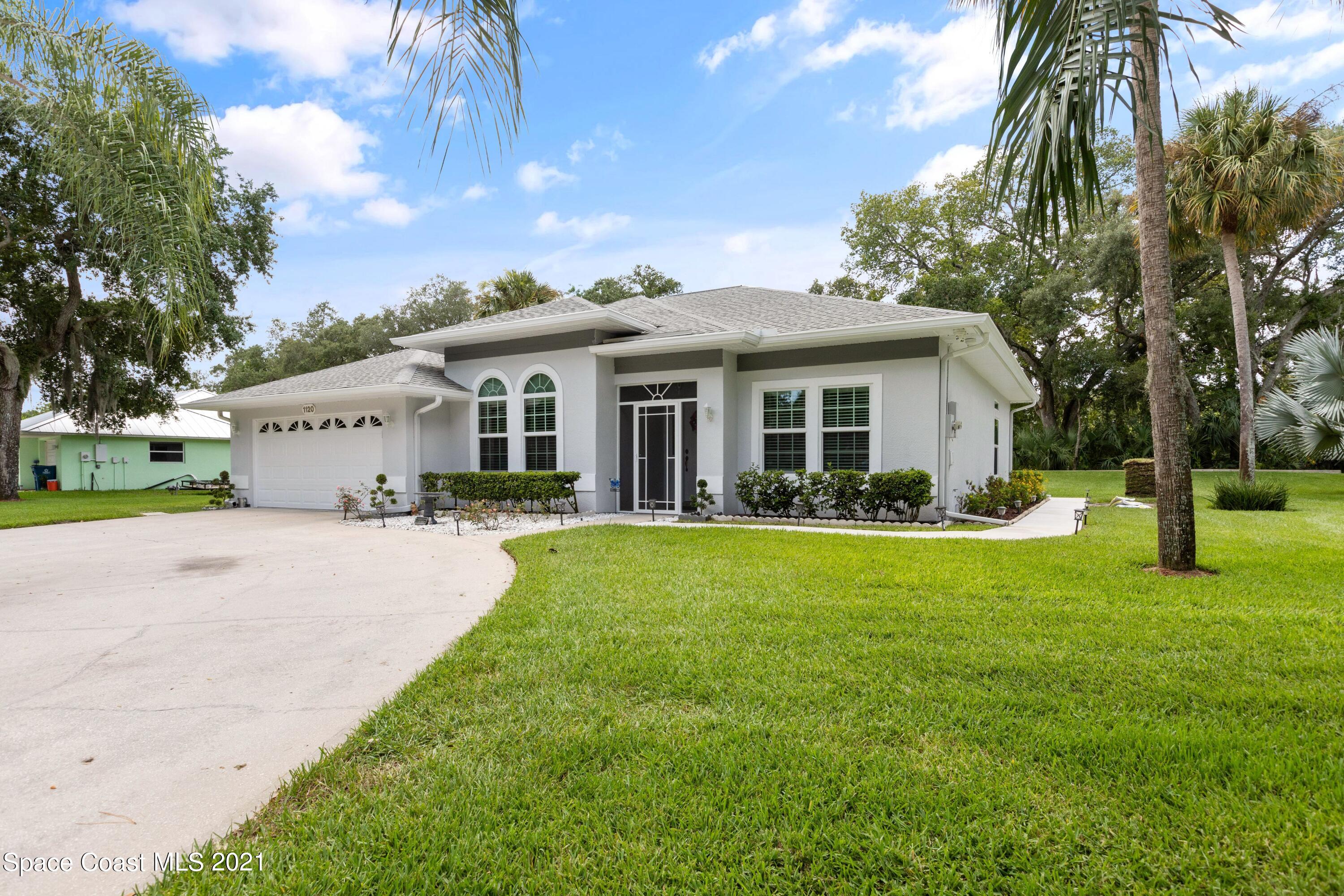 1120 Meadowbrook Road Northeast Palm Bay, FL 32905 - Photo 3 of 33 a view of a house with a yard and sitting area