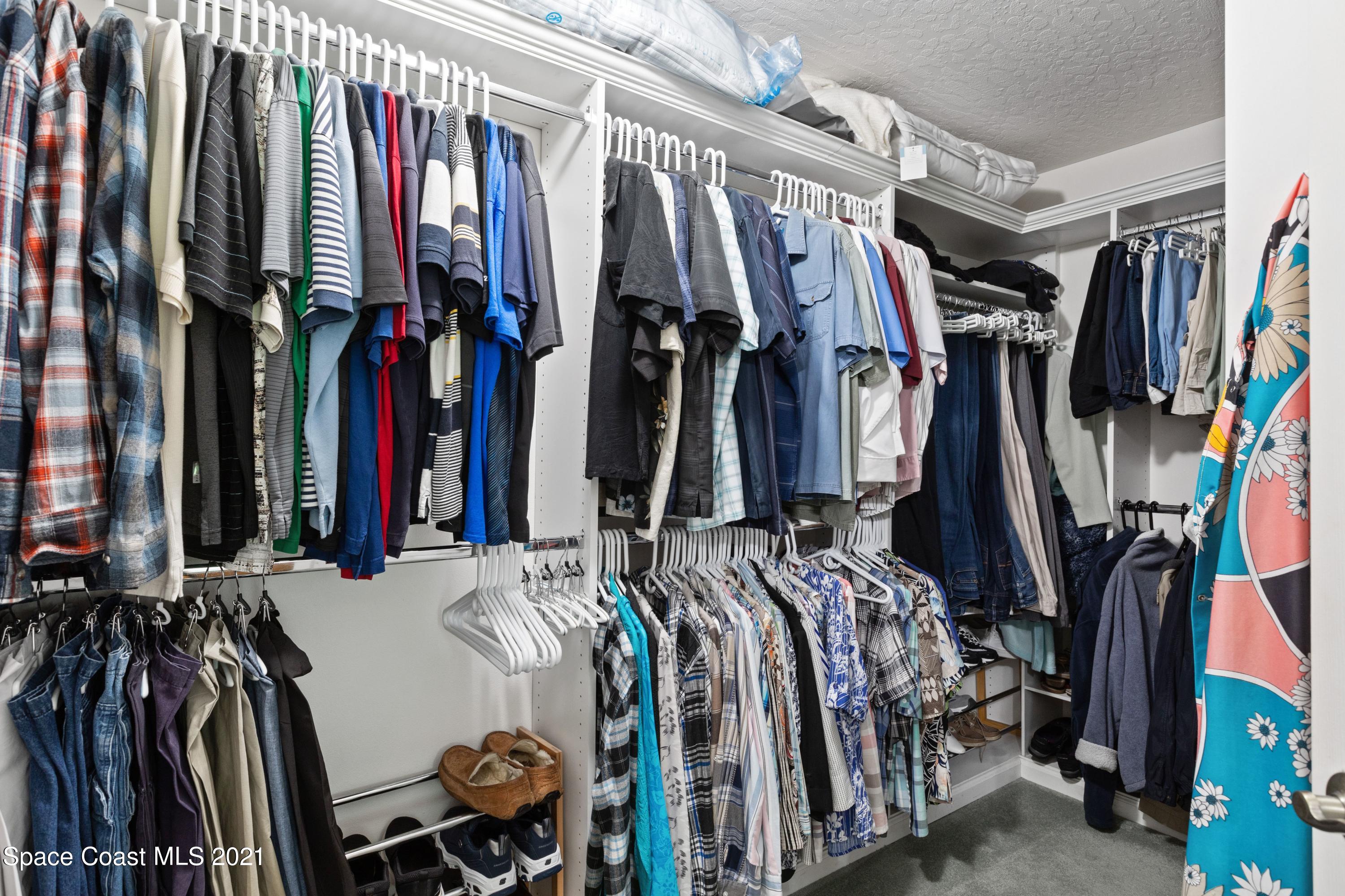1120 Meadowbrook Road Northeast Palm Bay, FL 32905 - Photo 21 of 33 a view of walk in closet with clothes