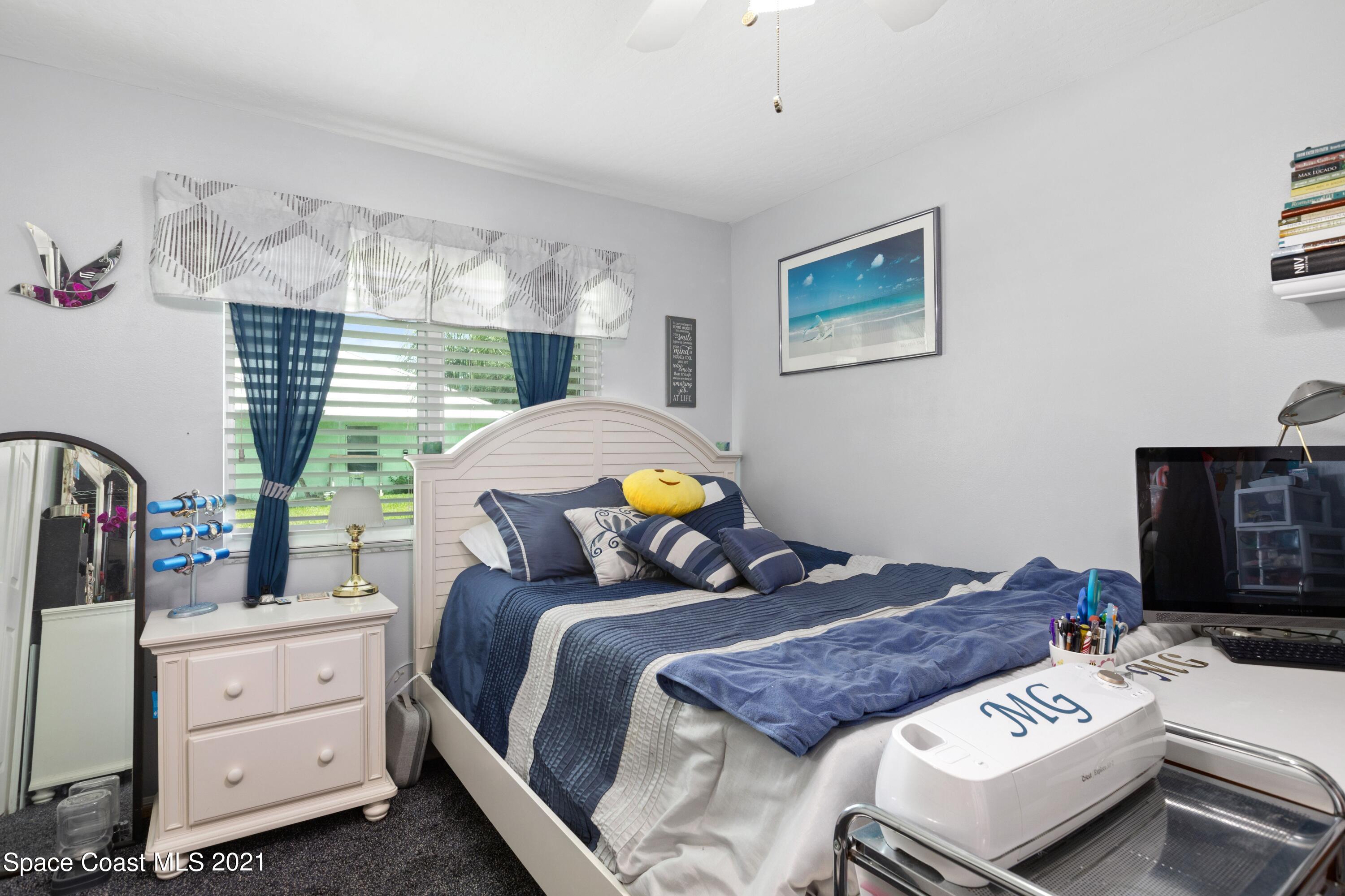 1120 Meadowbrook Road Northeast Palm Bay, FL 32905 - Photo 23 of 33 a bed room with a bed and a tv