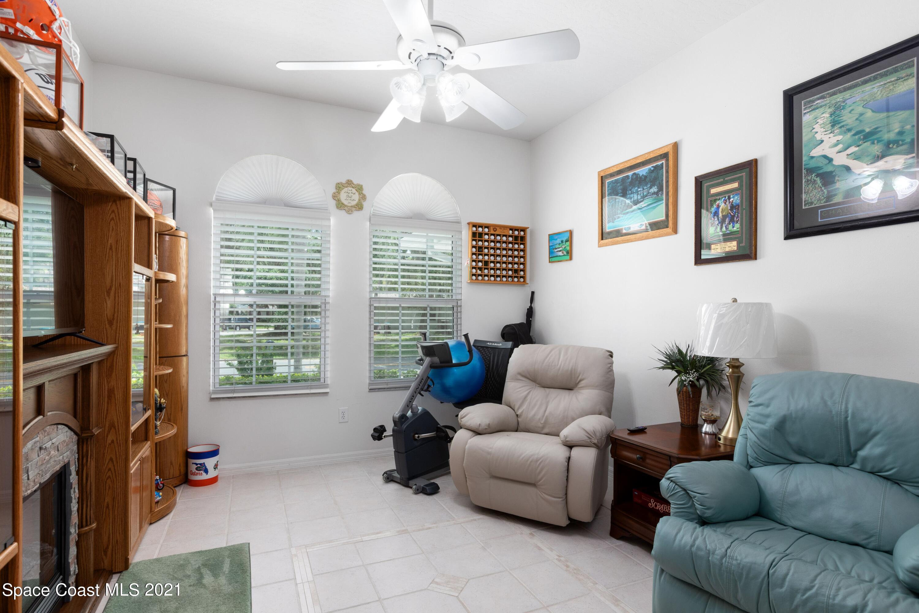 1120 Meadowbrook Road Northeast Palm Bay, FL 32905 - Photo 24 of 33 a living room with furniture a flat screen tv and a window