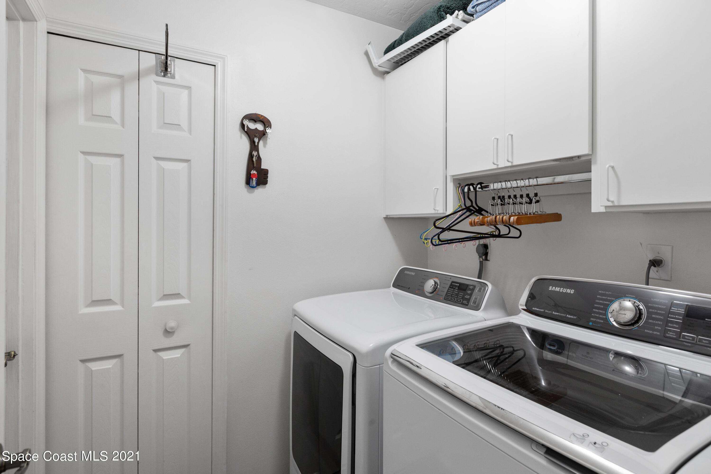 1120 Meadowbrook Road Northeast Palm Bay, FL 32905 - Photo 28 of 33 a utility room with dryer and washer