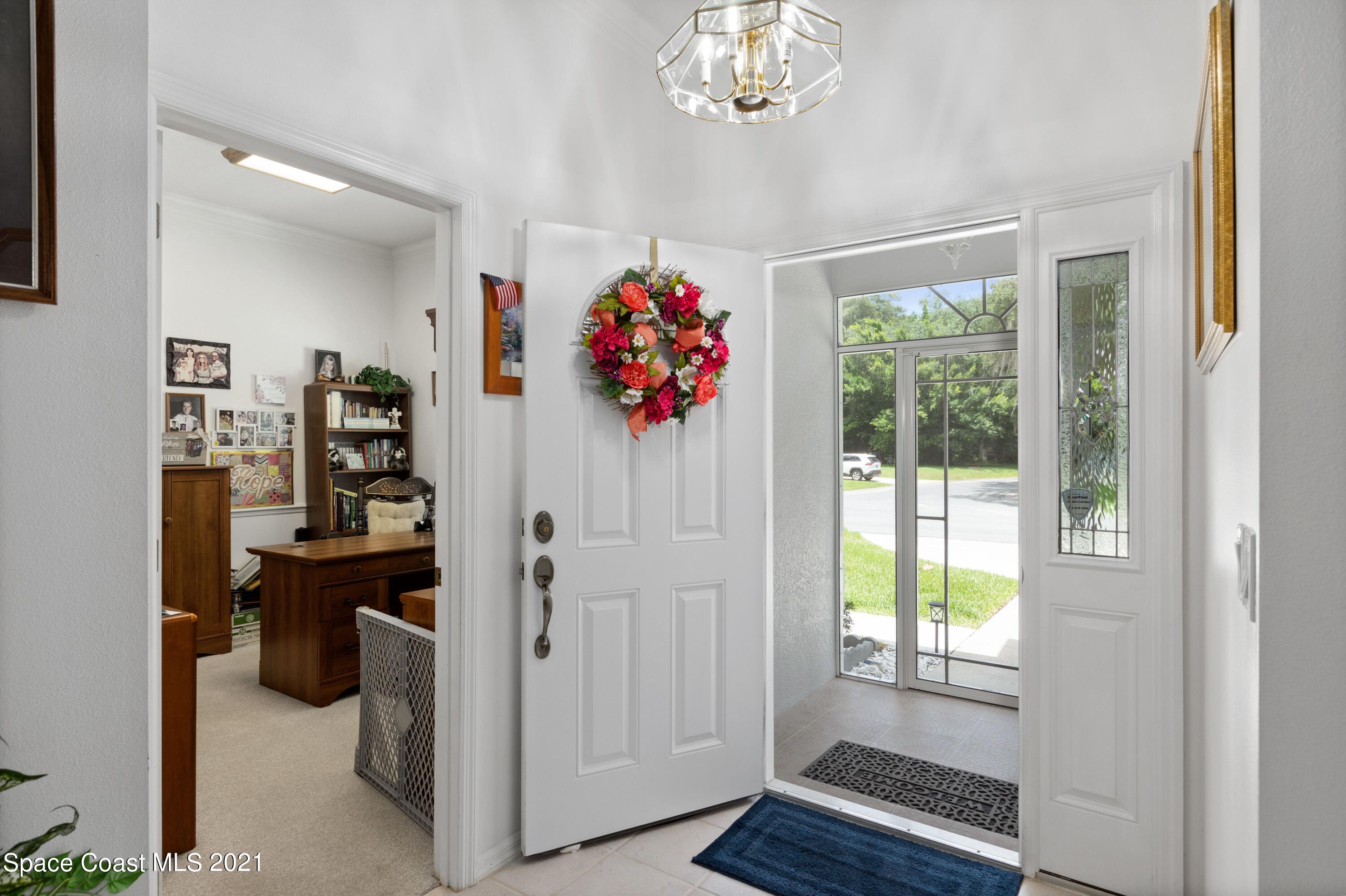 1120 Meadowbrook Road Northeast Palm Bay, FL 32905 - Photo 4 of 33 a view of a hallway with workspace and living room