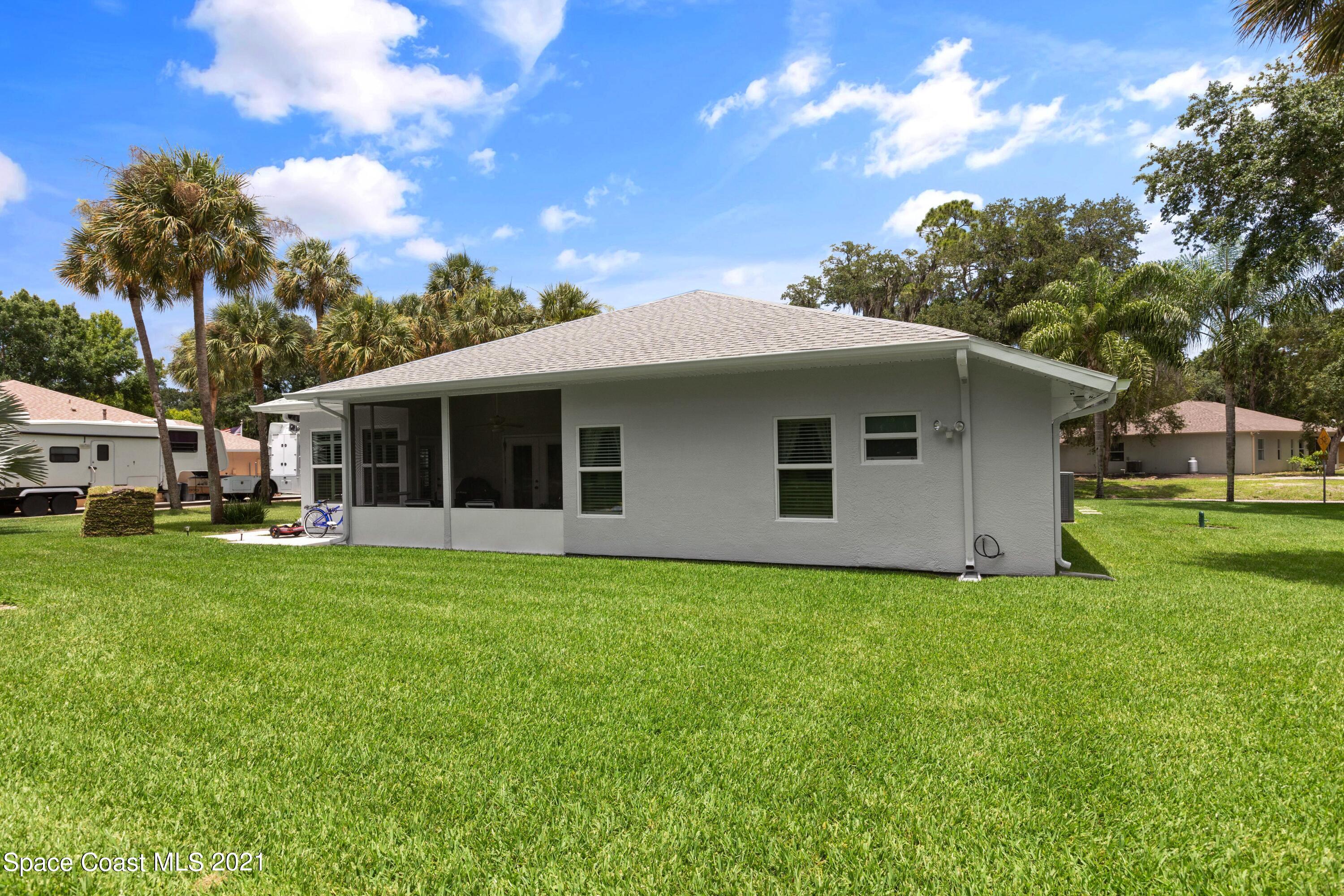 1120 Meadowbrook Road Northeast Palm Bay, FL 32905 - Photo 31 of 33 a front view of a house with a garden