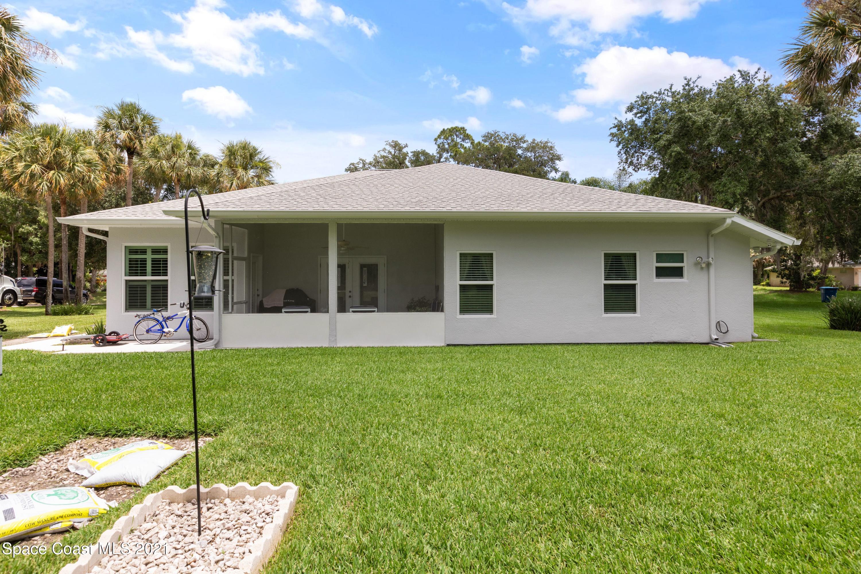 1120 Meadowbrook Road Northeast Palm Bay, FL 32905 - Photo 32 of 33 a view of a house with a backyard