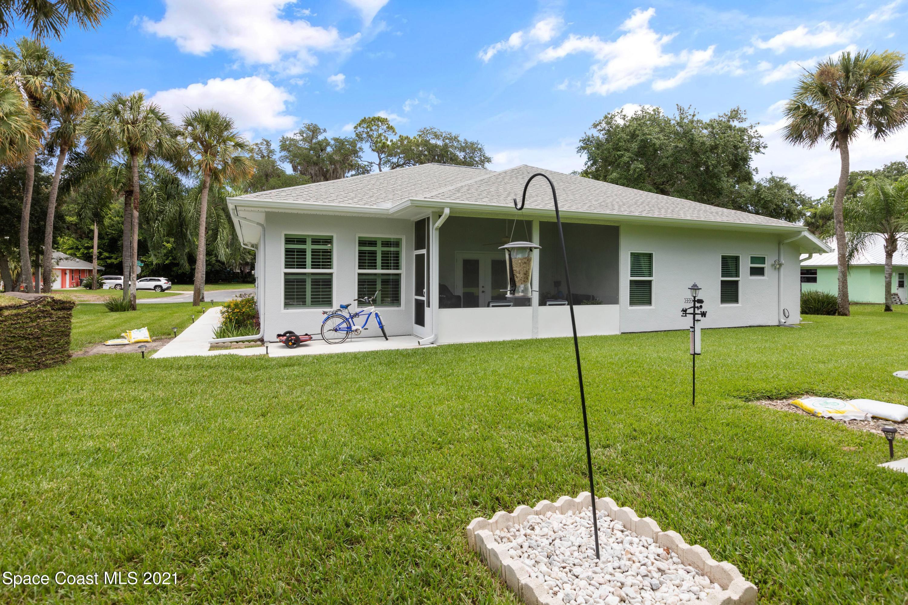 1120 Meadowbrook Road Northeast Palm Bay, FL 32905 - Photo 33 of 33 a view of a house with a backyard and a patio