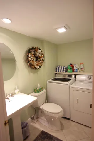 a bathroom with a sink mirror vanity and toilet