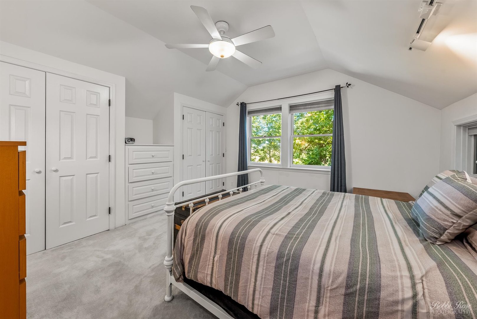 22489 Glidden Road DeKalb, IL 60115 - Photo 21 of 44 a spacious bedroom with a bed and a chandelier
