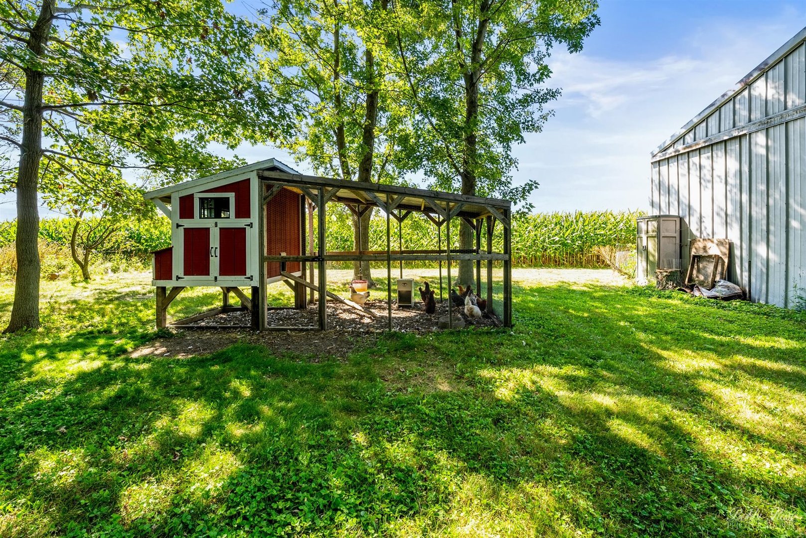 22489 Glidden Road DeKalb, IL 60115 - Photo 35 of 44 a view of a backyard with table and chairs and wooden fence