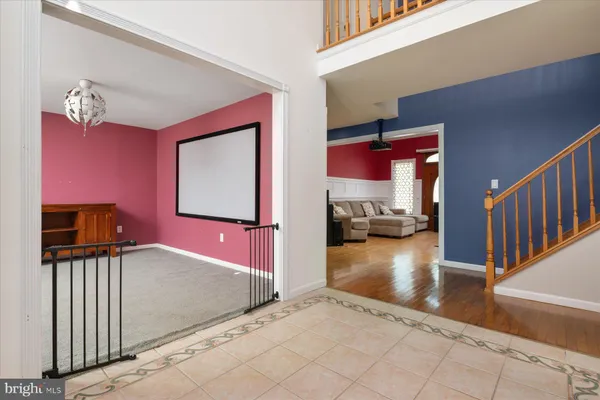 a kitchen with stainless steel appliances granite countertop a refrigerator a sink a stove and a wooden floors