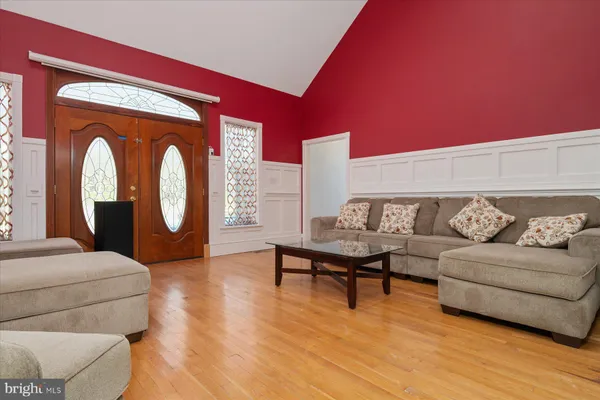 a kitchen with stainless steel appliances granite countertop a dishwasher a stove and white cabinets with wooden floor