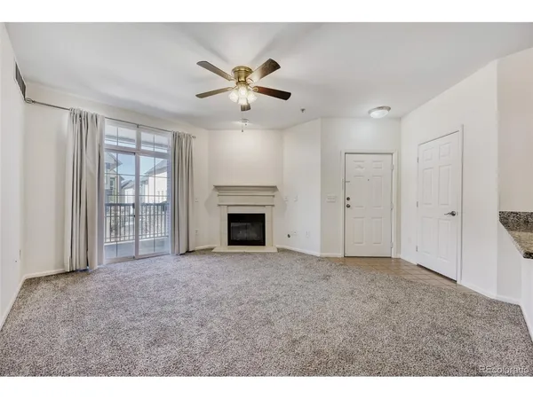 a view of empty room with windows and fireplace