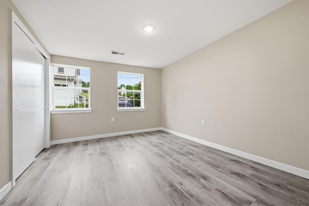 5641 North Coplay Road Whitehall, PA 18052 - Photo 25 of 68 A well-lit bedroom features durable laminate flooring and practical closet space.