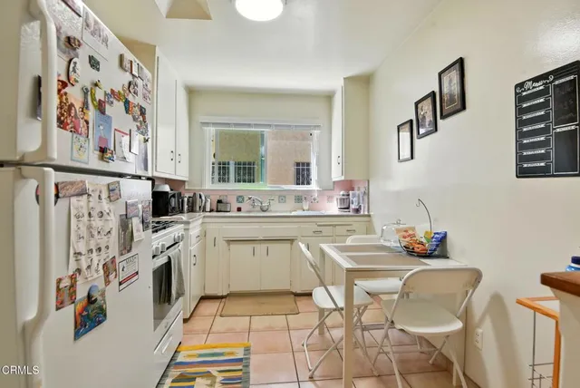 a living room with furniture white walls and a flat screen tv